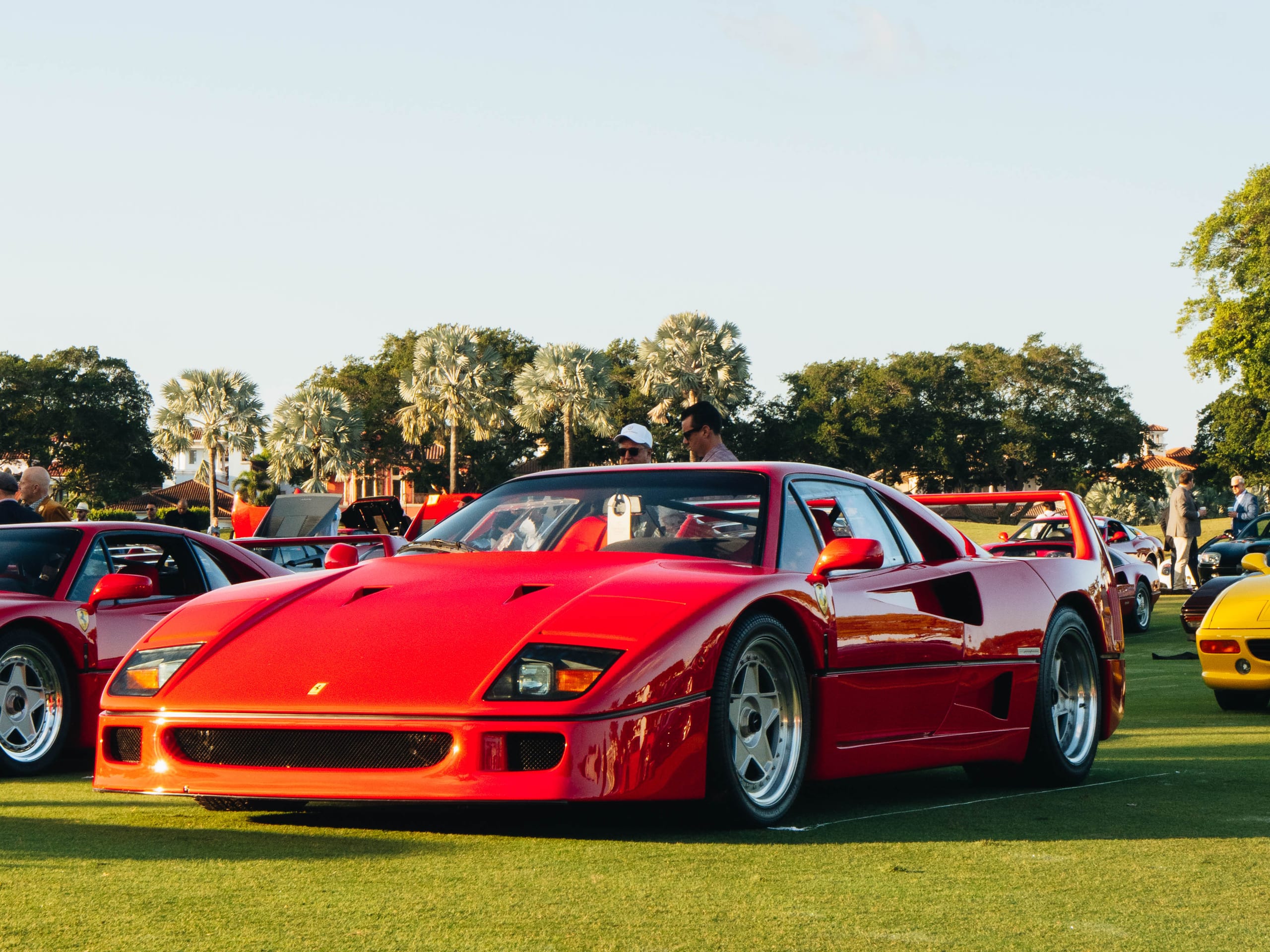 Ferrari F40 parked on the Cavallino Classic concours lawn with attendees in the background