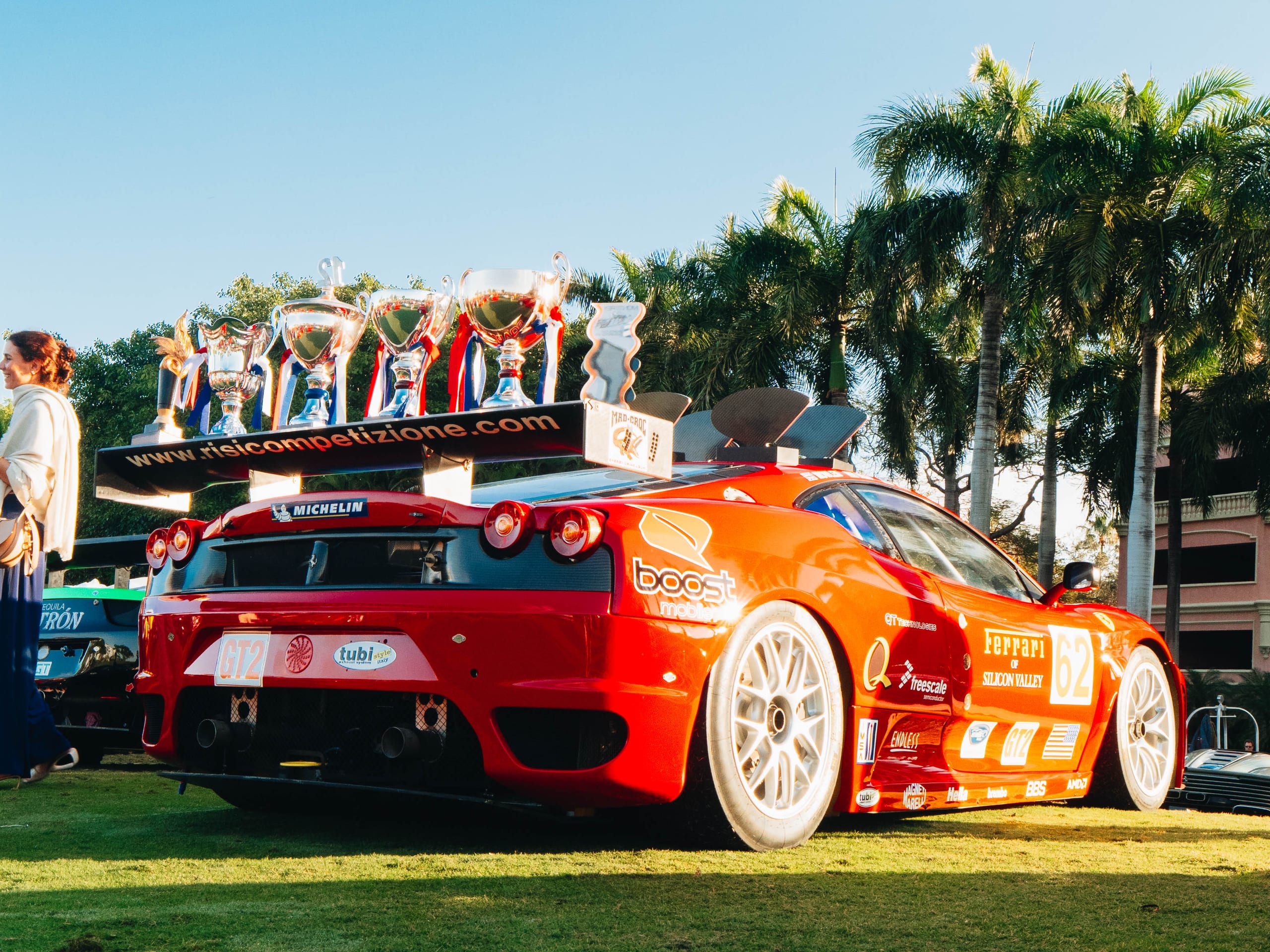 Ferrari F430 GT2 race car with championship trophies displayed on the rear wing