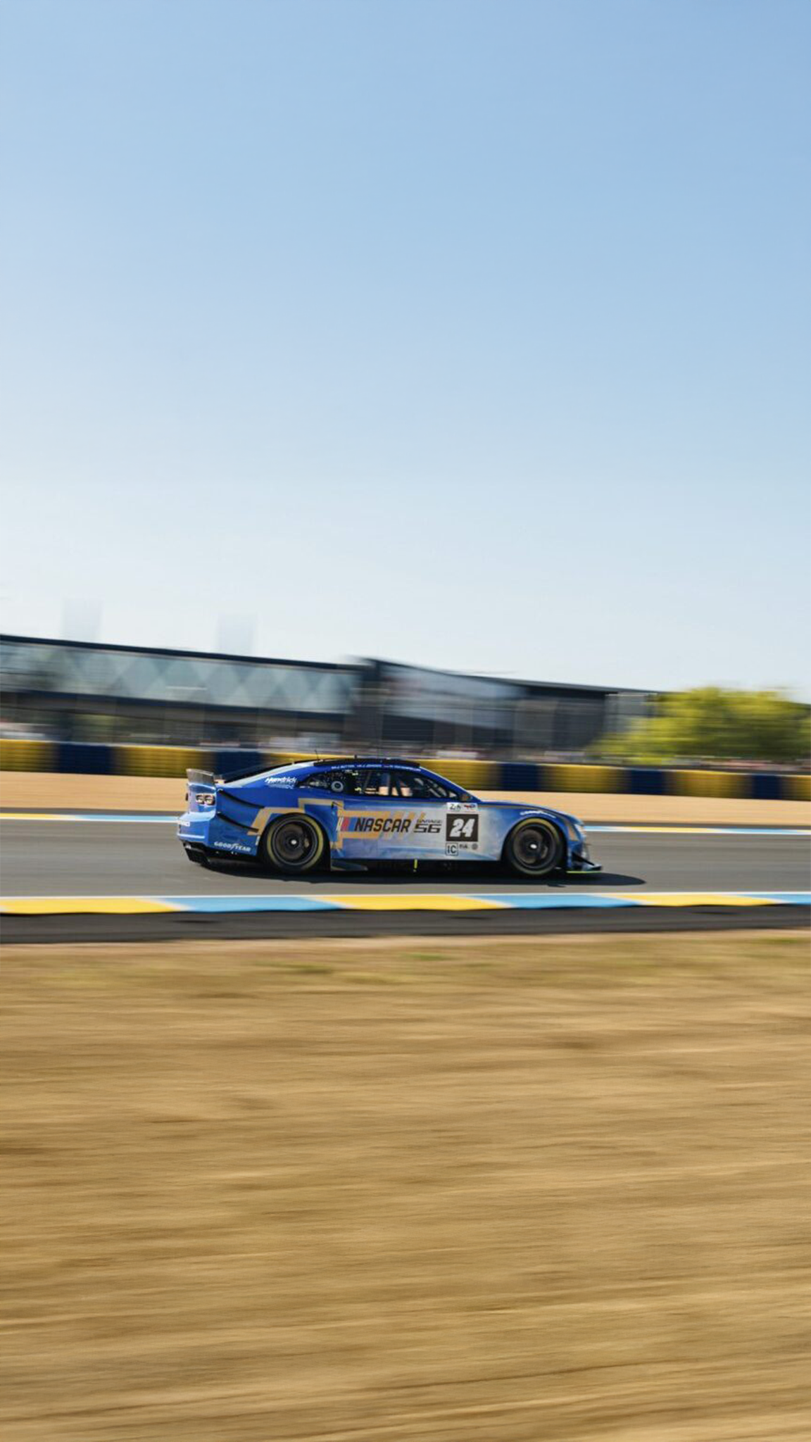 NASCAR Garage 56 car at speed in profile on a sunny race day