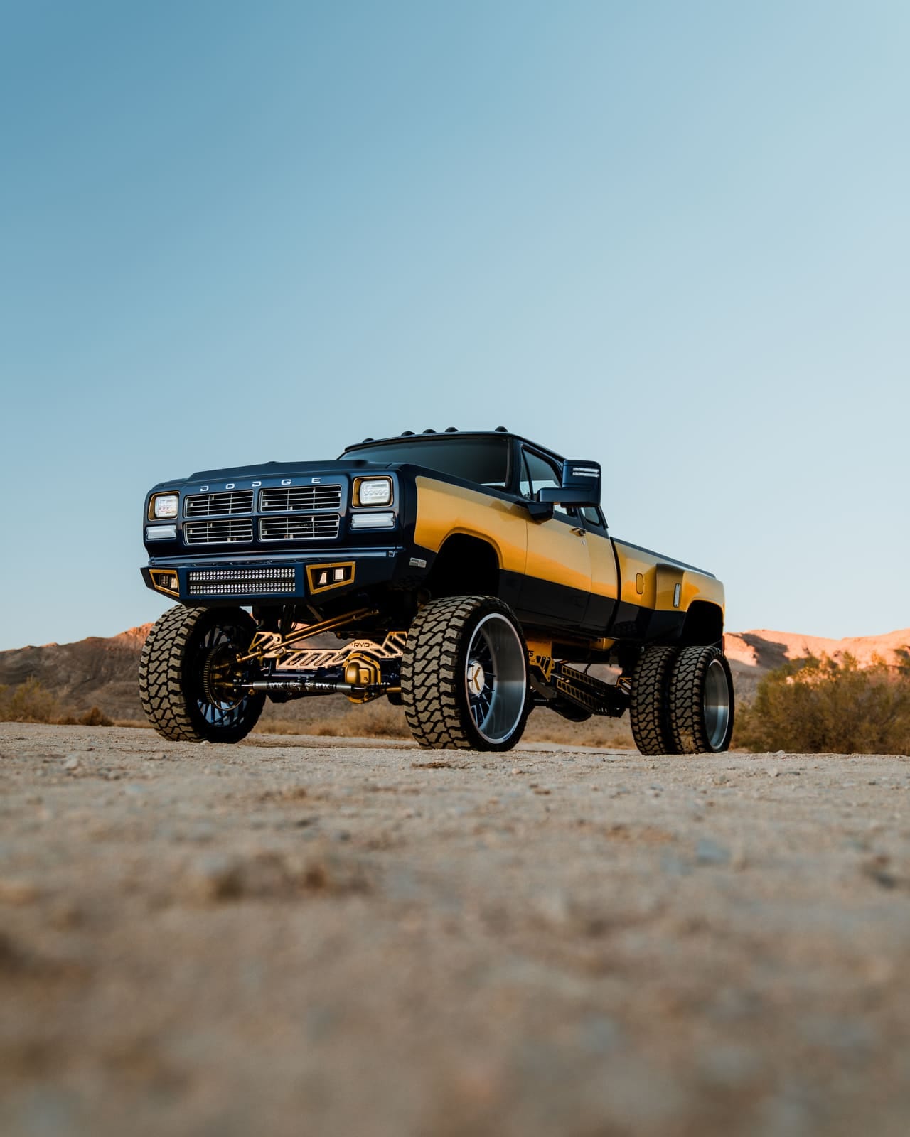 First-gen Dodge Ram dually on RYD Motorsports suspension at sunset in the desert