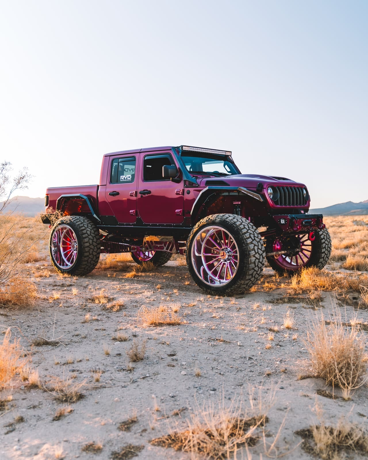 Magenta Jeep Gladiator build with color-matched wheels and RYD suspension in the desert