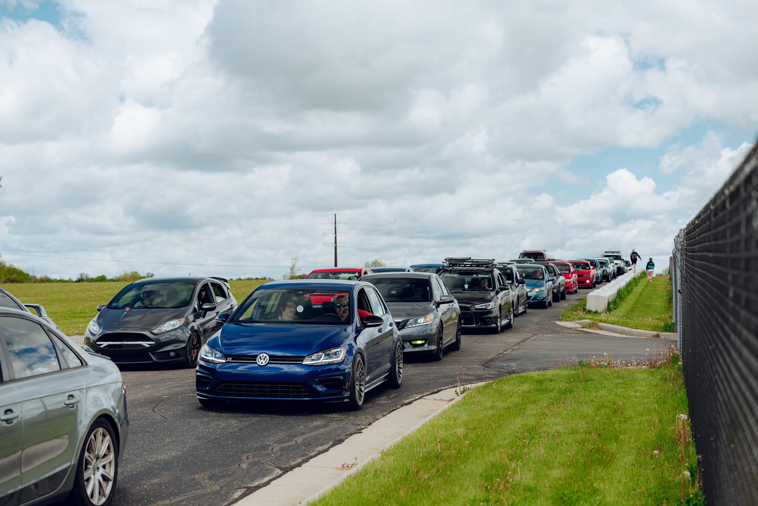 Feature vehicles and attendees at the Season Opener concourse