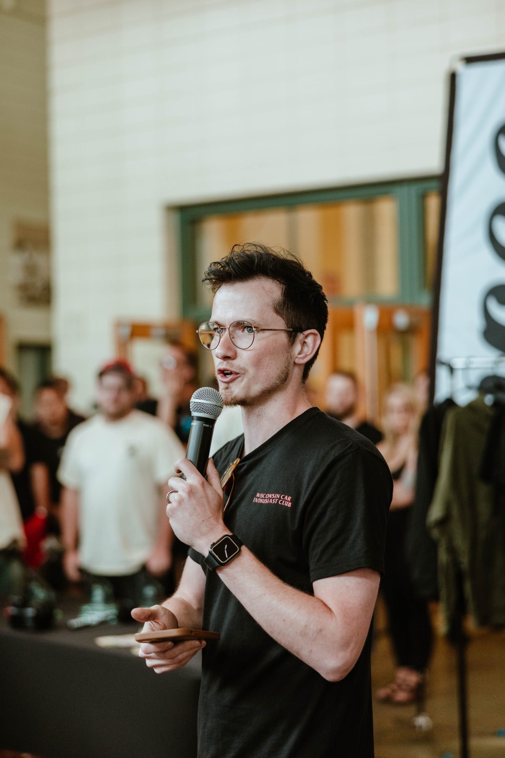 MetaMartini's Alex Martinez speaking into a microphone while presenting to a room