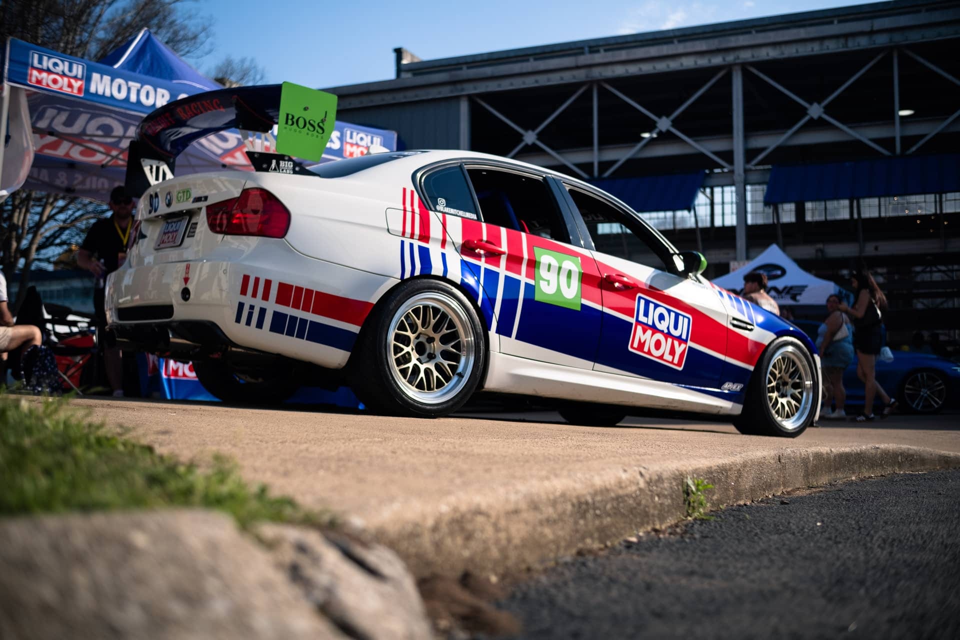 A Liqui Moly race car on display in the paddock at an automotive event