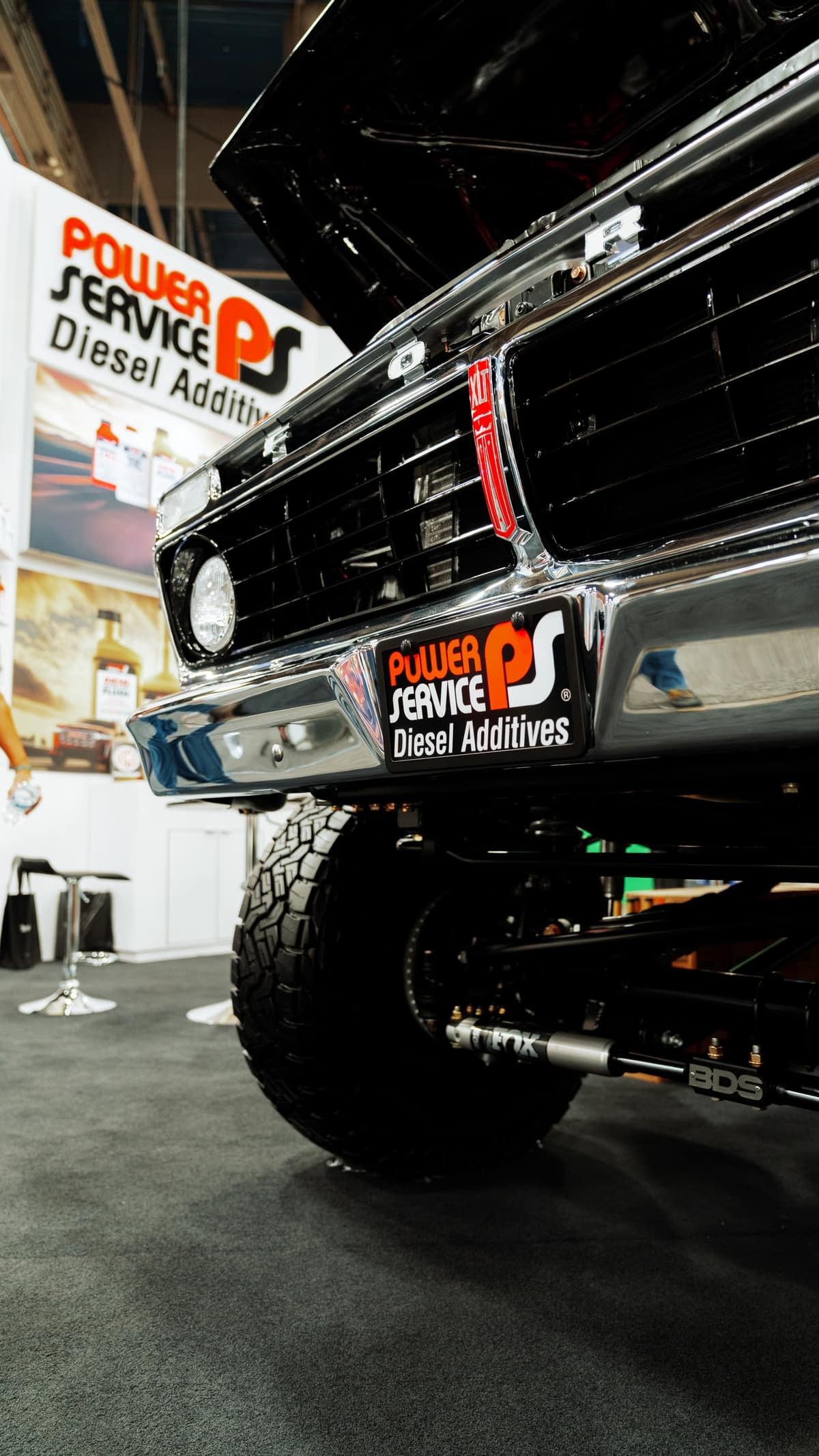 A show truck on display at the Power Service booth on a trade show floor