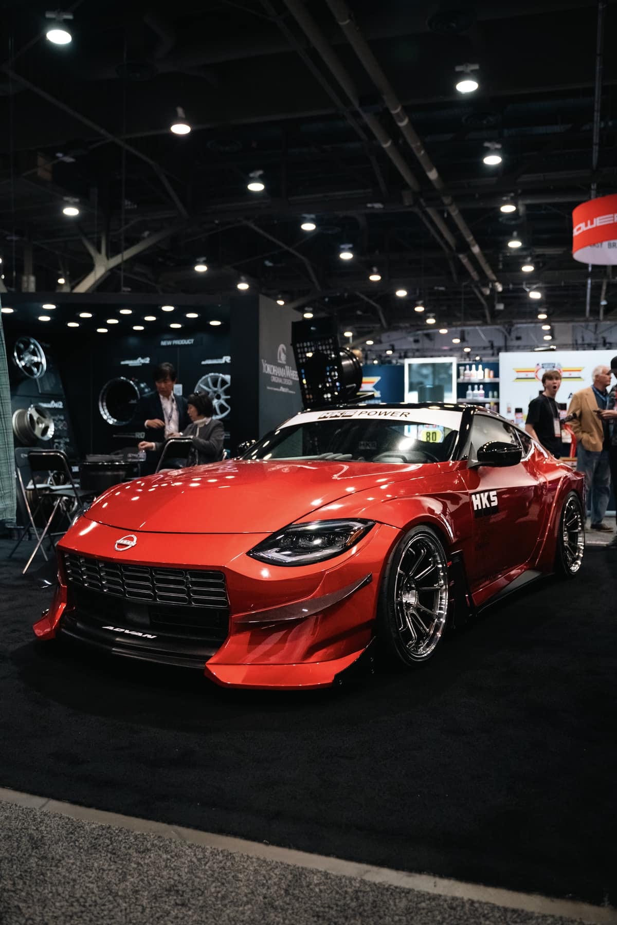 A widebody HKS Nissan Z show build at a trade show booth