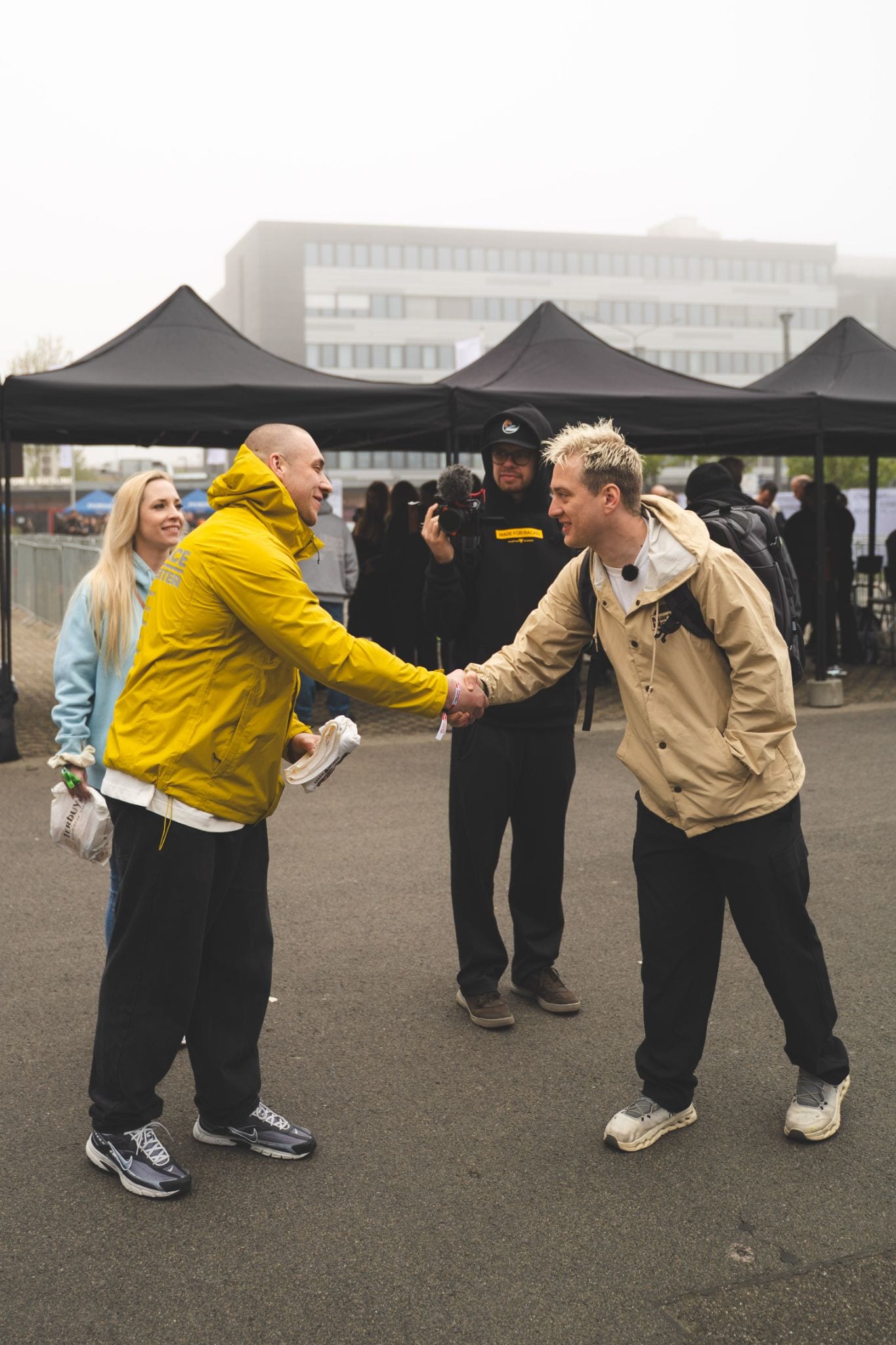 MetaMartini leadership shaking hands with a client partner at a brand activation