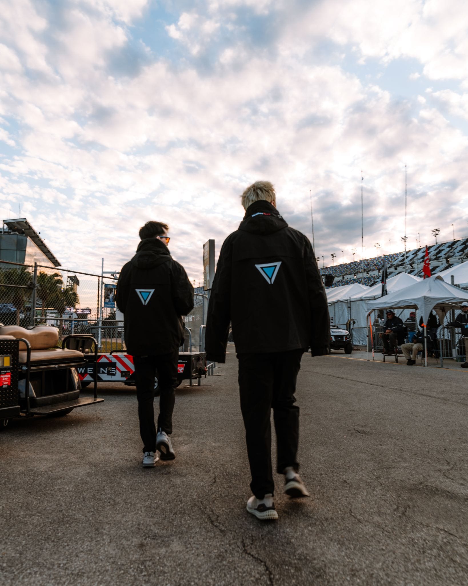 Two MetaMartini teammates walking through a race paddock during a launch campaign