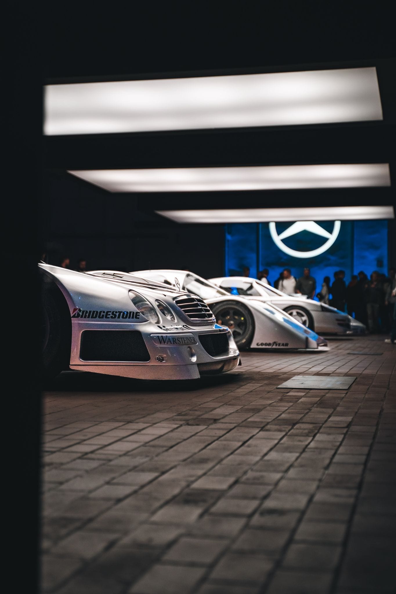 Mercedes-Benz heritage cars on display under spotlights at a brand event